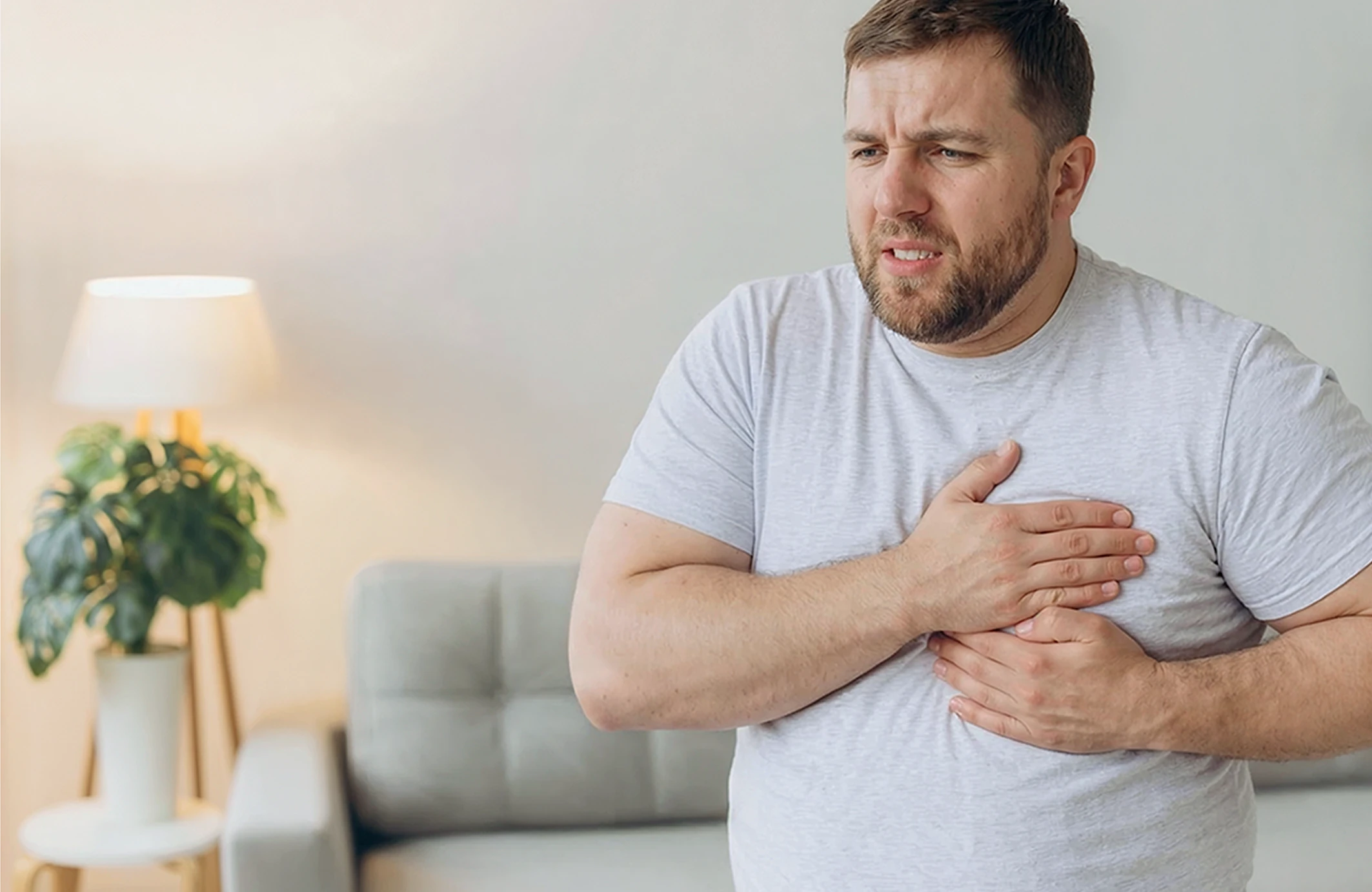man holding chest